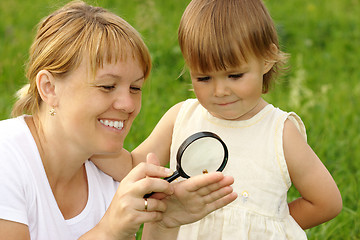 Image showing Child with mother looking at snail