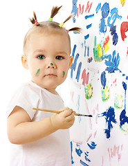 Image showing Little girl paint on a white board