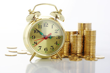 Image showing Time is money - clock dial and golden coins