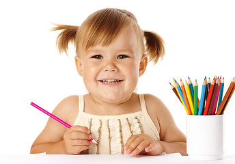 Image showing Happy child play with crayons and smile