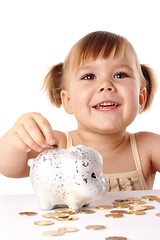 Image showing Cute little girl with piggybank