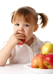 Image showing Child eats red apple