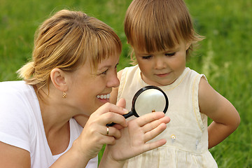 Image showing Child with mother looking at snail