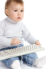 Image showing Cute child typing on a keyboard