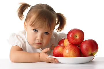 Image showing Suspicious child with apples