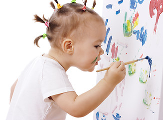 Image showing Little girl paint on a board