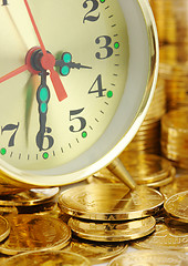 Image showing Time is money - clock dial and golden coins