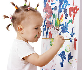 Image showing Little girl paint on a board