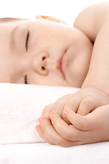 Image showing Sleeping little child, clasping his hands together