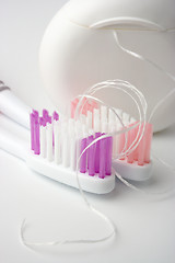 Image showing Two toothbrushes and dental floss