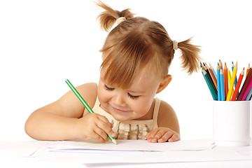 Image showing Cute child draw with color pencils and smile