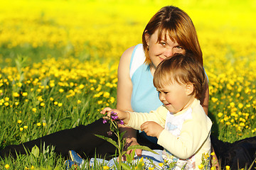 Image showing Mother and her child play on meadow