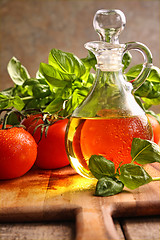 Image showing Bottle of olive oil with vegetables