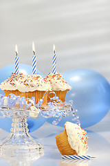 Image showing Birthday cupcakes with blue candles