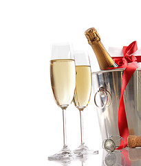 Image showing Glasses of champagne with red ribbon gift