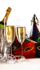 Image showing Glasses of champagne with masks and party hats