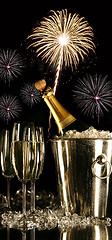 Image showing Glasses of champagne with fireworks