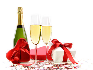 Image showing Glasses of champagne with bottle and gifts 