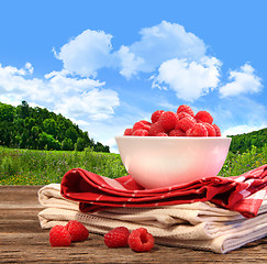 Image showing Bowl of raspberries on rustic table 