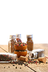 Image showing Spice bottles on rustic table