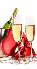 Image showing Champagne glasses with valentine gifts on white
