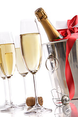 Image showing Glasses with Champagne in ice bucket and gift