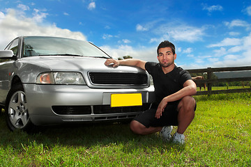 Image showing Man beside car in afternoon sun
