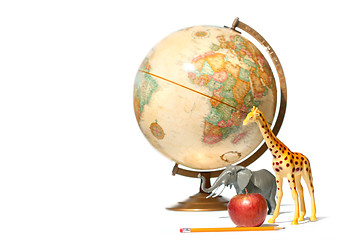 Image showing Globe with toy animals and apple on white