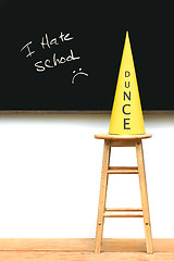 Image showing Yellow dunce hat on stool