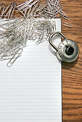 Image showing White pad with paper clips, school lock 