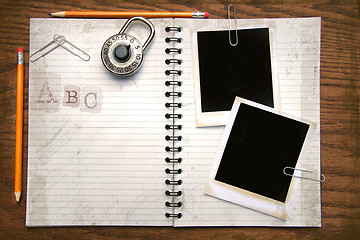 Image showing White copy book, pencils and photos