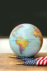 Image showing Globe and flag on school desk