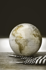 Image showing Globe and flag on school desk