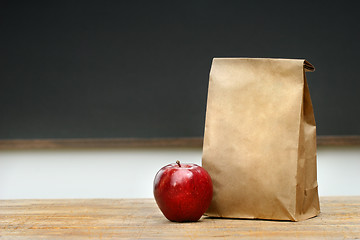 Image showing Paper lunch bag on desk 