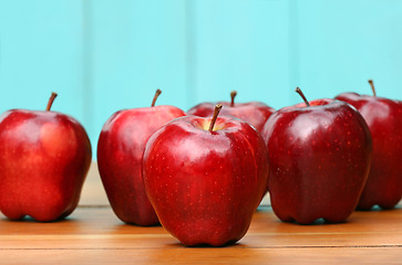 Image showing Red delicious apples on old school desk