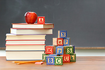 Image showing Pile of books with wooden blocks