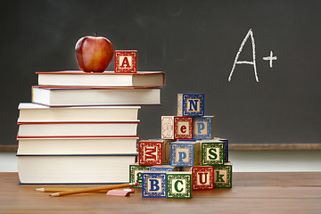 Image showing Pile of books with wooden blocks