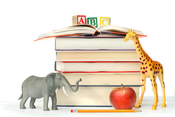 Image showing Stack of books with toy animals 
