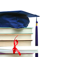 Image showing Stack of books with cap and diploma on white