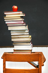 Image showing Stack of books on an old school desk 