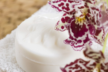 Image showing Spa items with white towels, natural soap and orchid