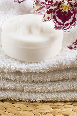 Image showing Spa items with white towels, natural soap and orchid