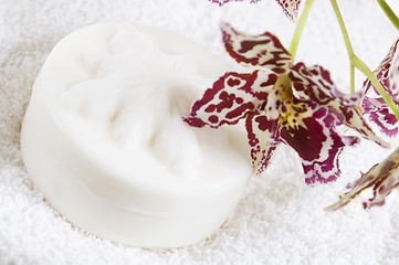 Image showing Spa items with white towels, natural soap and orchid