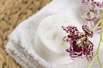 Image showing Spa items with white towels, natural soap and orchid