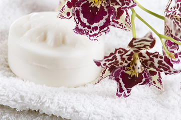 Image showing Spa items with white towels, natural soap and orchid