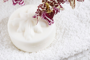 Image showing Spa items with white towels, natural soap and orchid