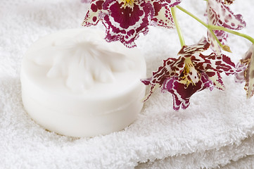 Image showing Spa items with white towels, natural soap and orchid