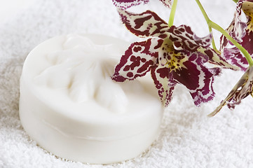 Image showing Spa items with white towels, natural soap and orchid