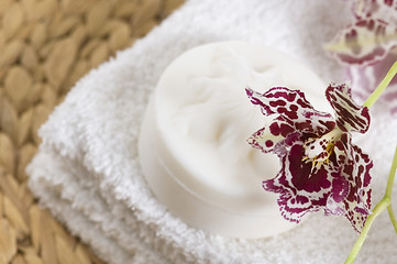 Image showing Spa items with white towels, natural soap and orchid