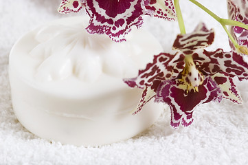 Image showing Spa items with white towels, natural soap and orchid